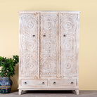 Image of a hand carved creme colour mango wood wardrobe wit 2 drawers and 4 shelfs and ample storage.