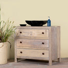 Side angle image of a reclaimed wood chest of 3 drawers with rustic finish and round knobs; Ibiza style sustainable furniture, 90 × 50 × 80 cm.