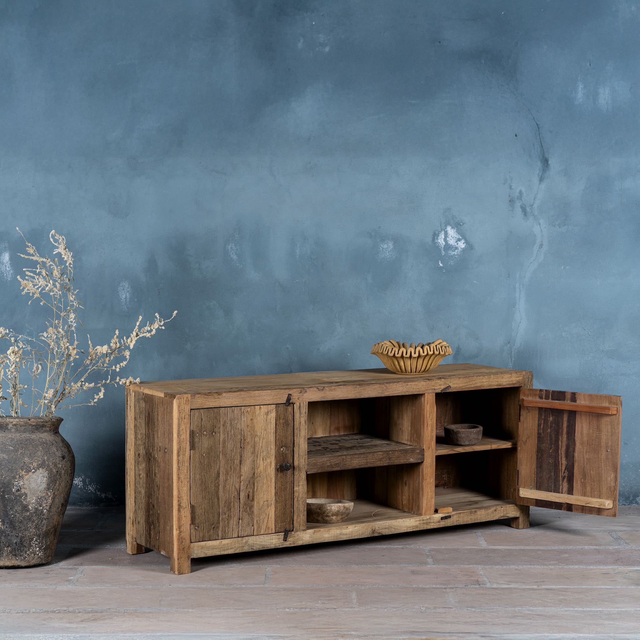 Side view image with open door of a driftwood lowboard made from reclaimed wood with two cabinets, open shelving, and rustic minimalist design, 150 × 40 × 60 cm.