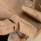 Close up image of antique teak wood oil grinder Jai with natural patina and hand-carved form. A vintage home accessory and unique Indian decoration ideal as a planter or entryway piece in vintage home decor settings.