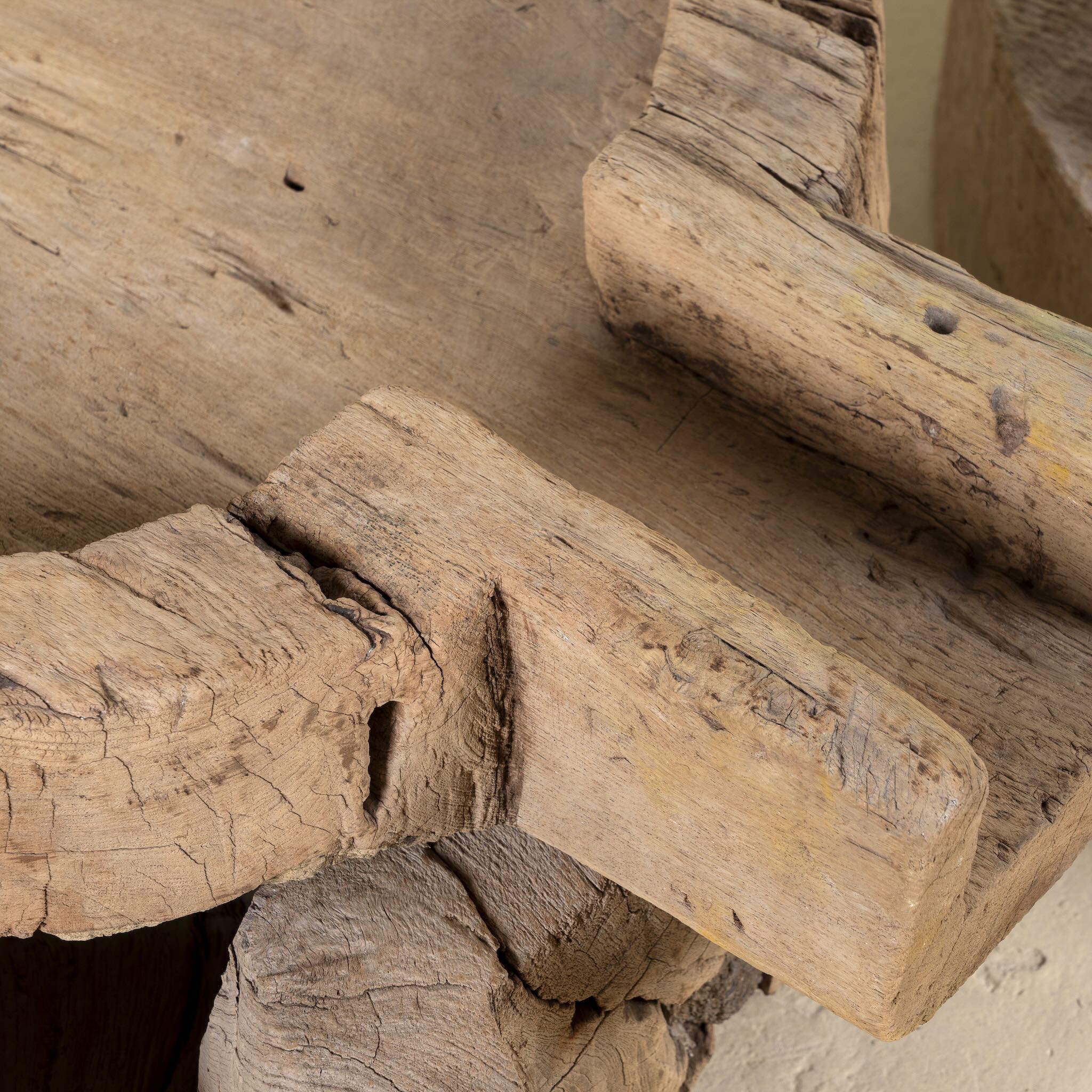 Close up image of antique teak wood oil grinder Jai with natural patina and hand-carved form. A vintage home accessory and unique Indian decoration ideal as a planter or entryway piece in vintage home decor settings.