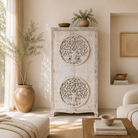 Lifestyle imagination of a White washed armoire with hand-carved Tree of Life motif, mango wood carved wood furniture with storage, 90 × 40 × 180 cm.