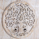 Close up image of a white washed armoire with hand-carved Tree of Life motif, mango wood carved wood furniture with storage, 90 × 40 × 180 cm.
