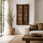 Lifestyle image of a Jain antique door Indian from a historic Jain temple, made from aged teakwood with original brass fittings—an extraordinary piece of spiritual architecture and unique wooden furniture.