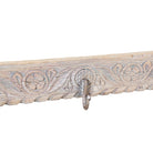 Close up image of a Jaipur Wall Hook Rack handcrafted from an antique Indian reclaimed wood architectural element with hand-carved floral details, bleached finish and seven iron hooks, 150x7x5cm.