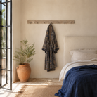 Lifestyle image of a Jaipur Wall Hook Rack handcrafted from an antique Indian reclaimed wood architectural element with hand-carved floral details, bleached finish and seven iron hooks, 150x7x5cm.