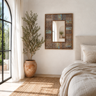 Lifestyle image of a of a rectangular mango wood mirror with reclaimed wood patchwork frame and distressed finish; perfect for vintage home decor and bohemian styling, 64 × 5 × 84 cm.