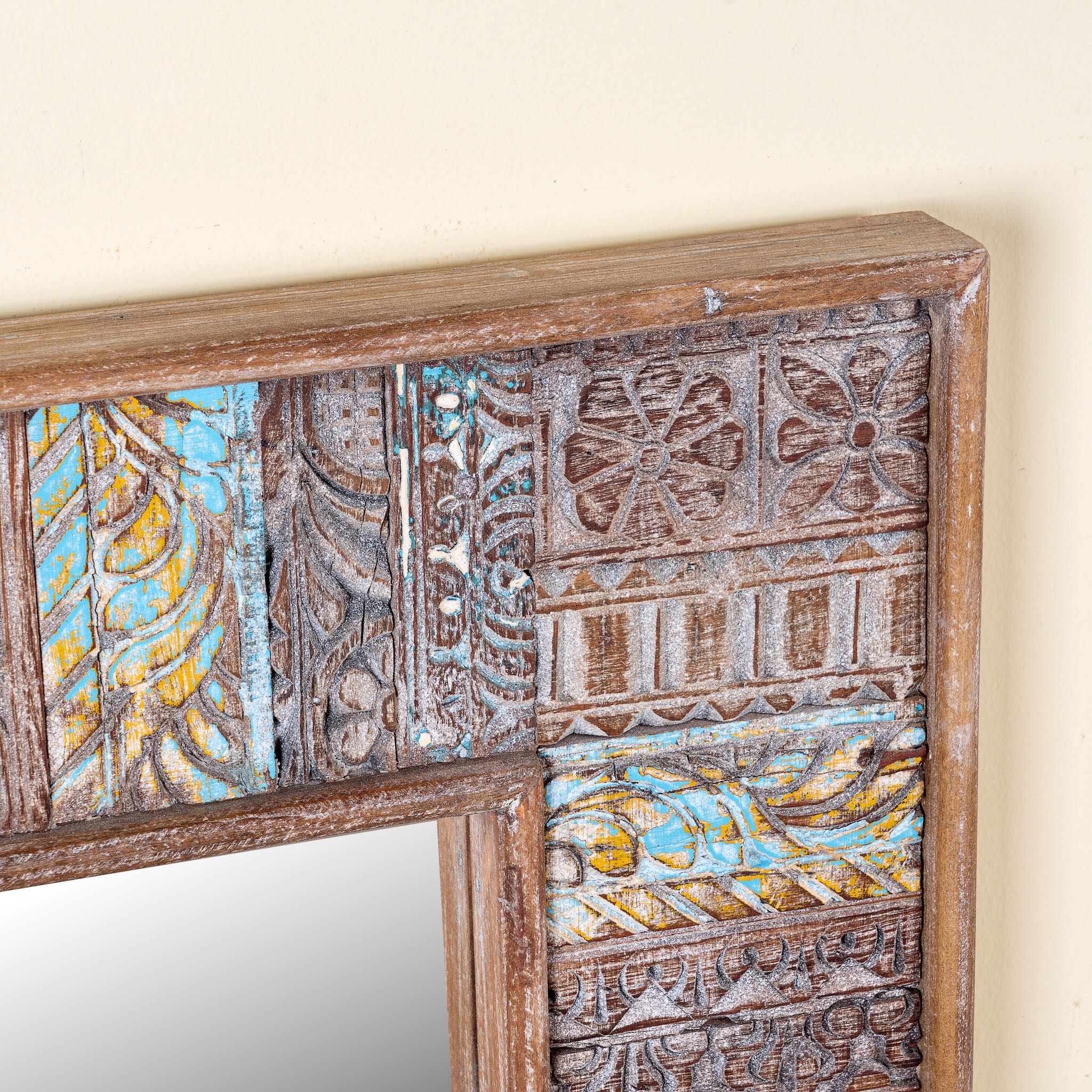 Close up image of a rectangular mango wood mirror with reclaimed wood patchwork frame and distressed finish; perfect for vintage home decor and bohemian styling, 64 × 5 × 84 cm.