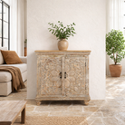 Lifestyle image of a square carved wood sideboard with whitewashed floral detailing; ideal as living room furniture, 90 × 90 × 40 cm.