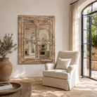 Lifestyle image of a hand-carved wall mirror Jamnagar made from solid mango wood with floral design. A bold piece of Indian furniture online blending craftsmanship and natural beauty.