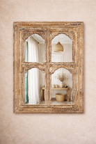 Lifestyle imagination of a hand-carved wall mirror Jamnagar made from solid mango wood with floral design. A bold piece of Indian furniture online blending craftsmanship and natural beauty.