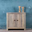 Lifestyle image of a rustic cupboard made of reclaimed wood with two doors, sustainable bathroom furniture, 90 × 40 × 86 cm.