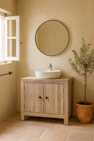 Lifestyle inspiration for a white background image of a rustic cupboard made of reclaimed wood with two doors, sustainable bathroom furniture, 90 × 40 × 86 cm.