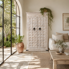 Lifestyle image of a handcrafted cabinet made from reclaimed wood with white-washed finish and Indian carvings – sustainable furniture and unique Indian furniture with cultural depth.