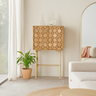 Lifestyle imagination of a tall mango wood cabinet in grey sandblasted finish with geometric sunburst design and brass handles, 76 × 38 × 135 cm.