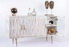 Side angle image with open door of a whitewashed mango wood sideboard with raised criss-cross design, four doors, and silver metal legs—elegant living room furniture with modern rustic appeal.