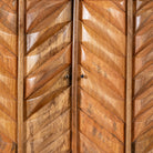 Close up image of a handcrafted mango wood cabinet with raised chevron design and brass handles – Jayapal by Om Home & Garden