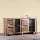 Image with open doors of a boho style hand painted sideboard with reclaimed old Indian door decoration. Unique cabinet with floral design.