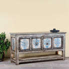 Side angle image of a hand painted console table with 2 doors and plenty of inside storage made of reclaimed old wood in Boho style.