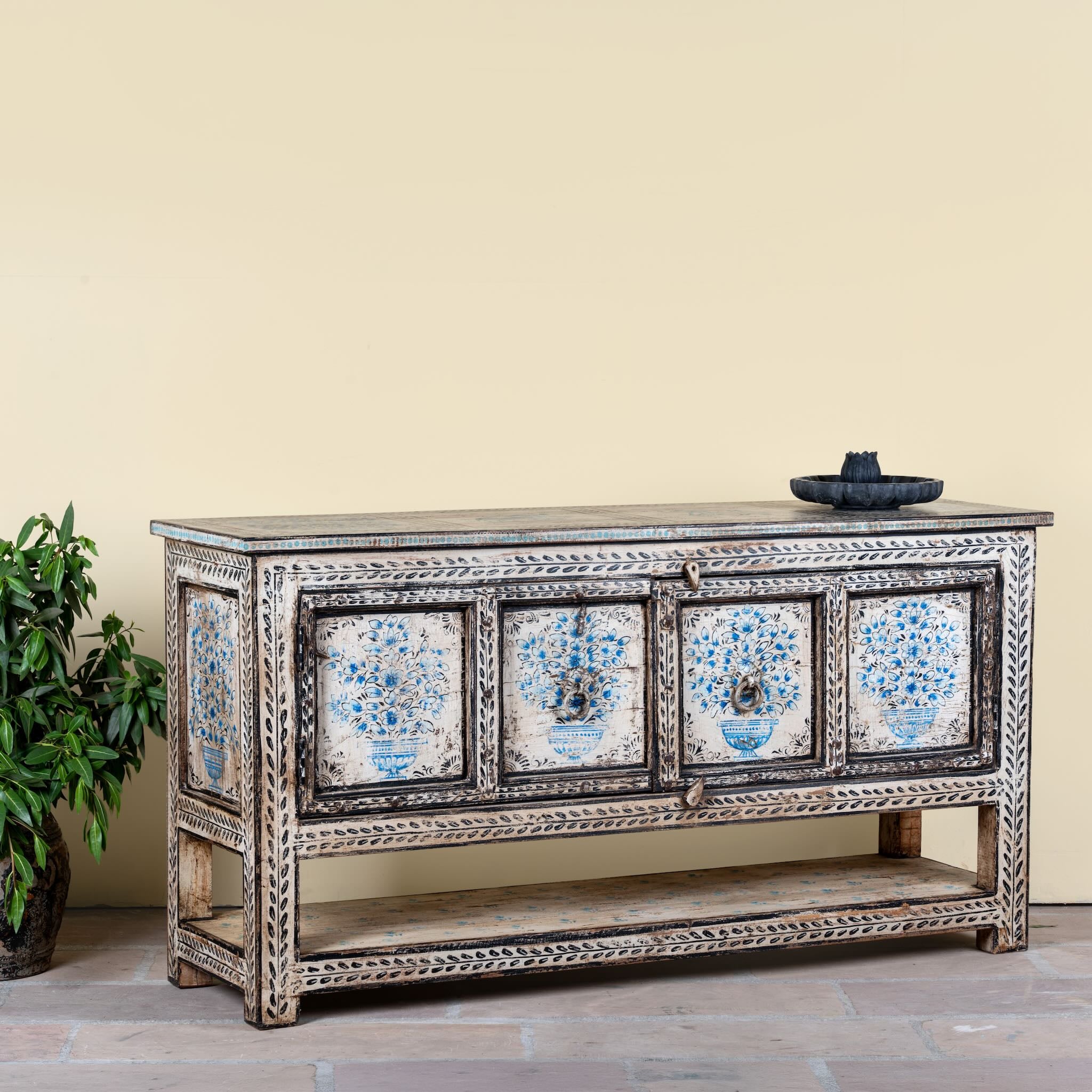 Side angle image of a hand painted console table with 2 doors and plenty of inside storage made of reclaimed old wood in Boho style.