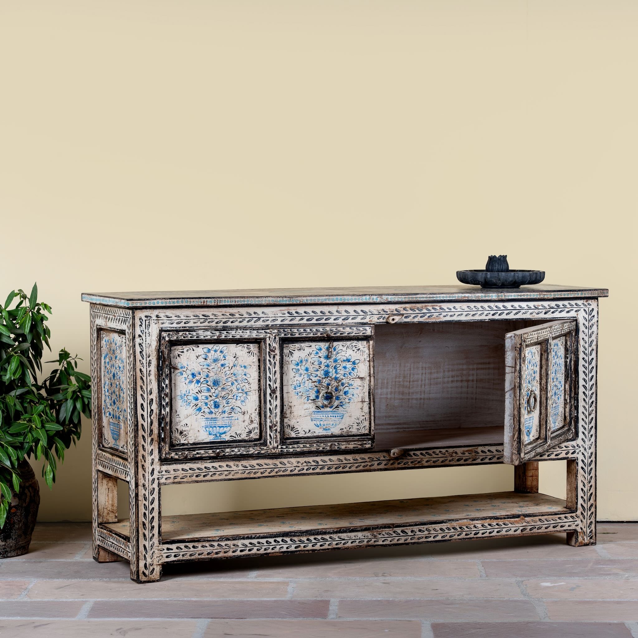 Side angle image with open doors of a hand painted console table with 2 doors and plenty of inside storage made of reclaimed old wood in Boho style.