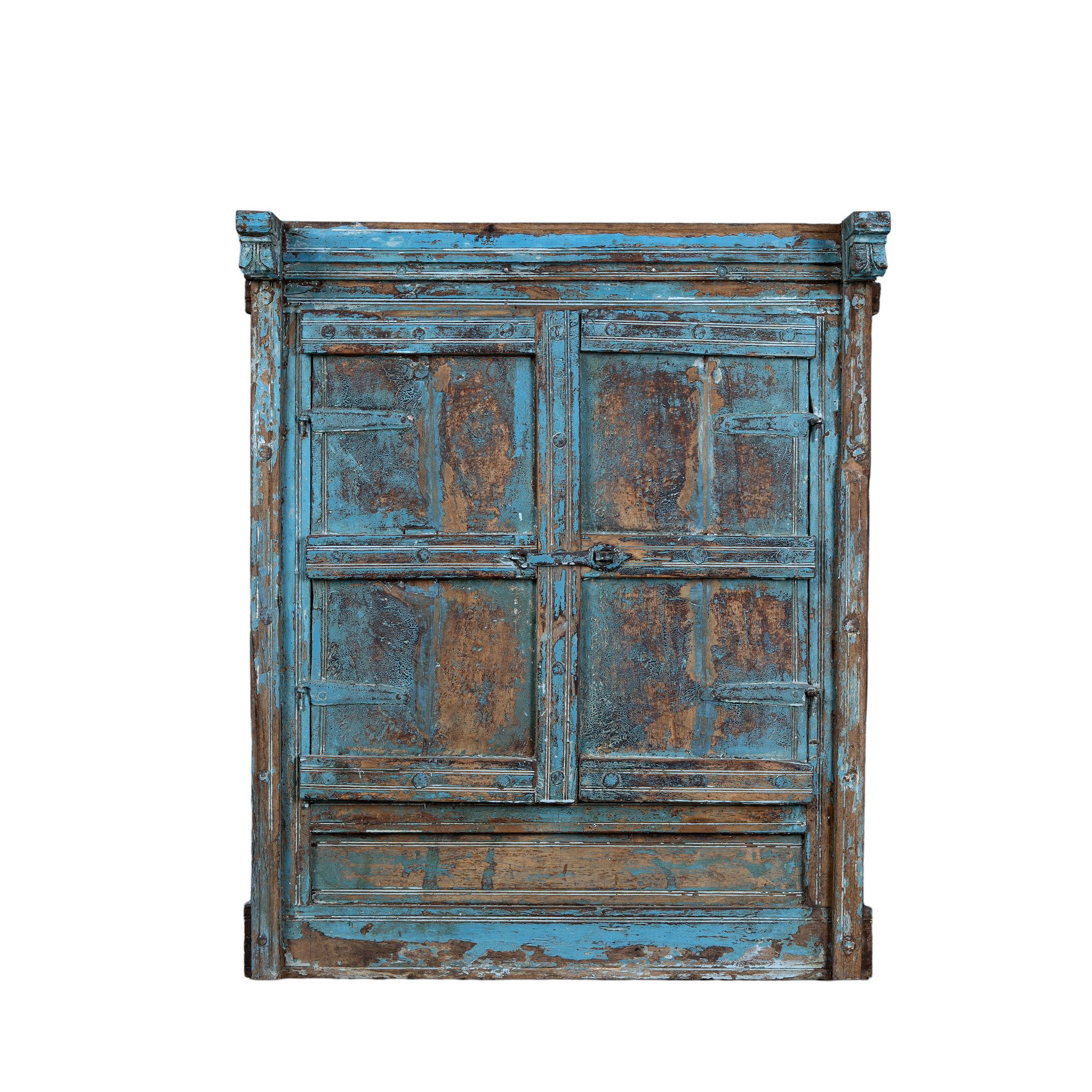 White background image of an antique teak window mirror with blue paint and shutters, vintage wall panel design from our vintage home accessories range.