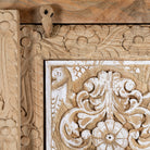 Close up image of a hand carved wooden wardrobe made of solid mango wood with whitewashed floral details; Ibiza-style mango wood wardrobe, 190 × 100 × 40 cm.