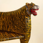 Close up image of the head of a hand-painted Tiger bench with double tiger heads and hand-painted stripes; unique furniture made from reclaimed teak, 160 × 70 × 90 cm.