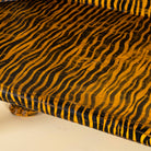 Close up image of a hand-painted Tiger bench with double tiger heads and hand-painted stripes; unique furniture made from reclaimed teak, 160 × 70 × 90 cm.