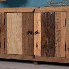 Close up image of a sustainable driftwood furniture lowboard made from reclaimed wood with four cabinets and rustic finish; 230 × 45 × 60 cm.