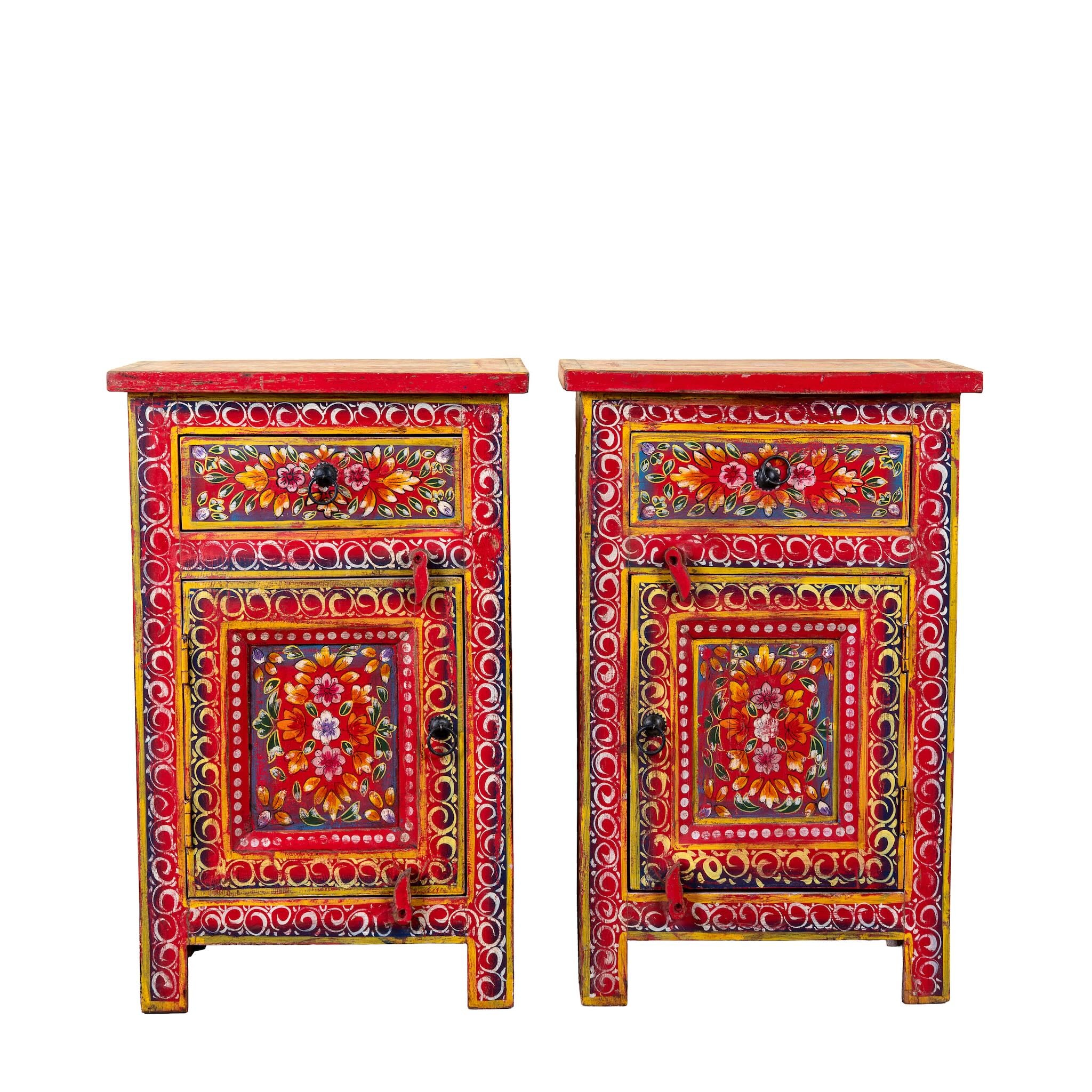 White background image of a Joven pair of hand painted reclaimed wood nightstands with one drawer, one cabinet door, floral artwork, and vibrant red boho style finish.