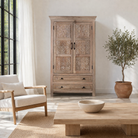 Lifestyle suggestion for a hand-carved mango wood cabinet with floral and geometric detailing – carved wooden furniture and elegant bedroom storage by Om Home & Garden.