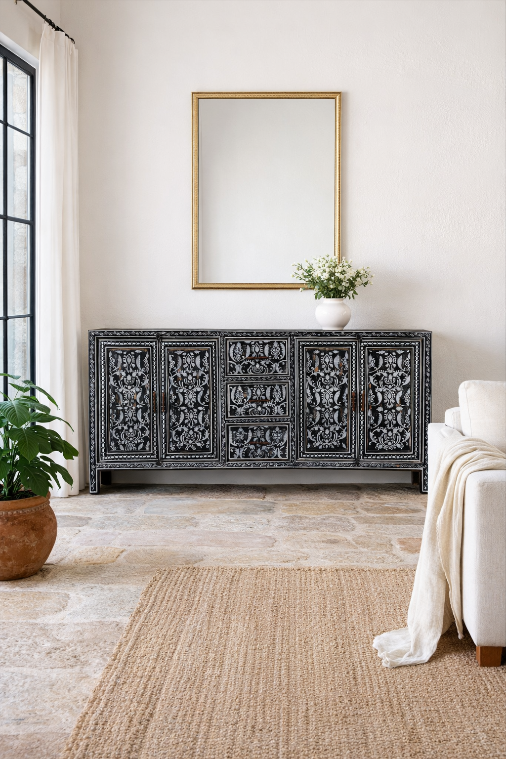 Lifestyle imagination of a of a hand-painted black and white sideboard made of reclaimed wood – Kaira model by Om Home & Garden