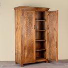 Side angle image with open door of a Kalki hand carved mango wood wardrobe with botanical carved doors, removable shelves and hanging rail, 110x56x190cm