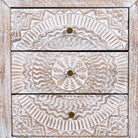 Close up image of a set of two hand carved night stands in solid mango wood with mandala motifs; white washed furniture, 50 × 40 × 60 cm.