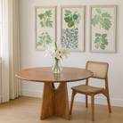 Lifestyle imagination of a round mango wood dining table with natural grain and sturdy base; solid wooden dining table for dining rooms, 130 cm diameter × 100 cm height.