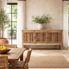 Lifestyle imagination of a console table made from old teak door panels, featuring traditional hand-carved details, iron ring accents, and built-in storage in a natural rustic finish.