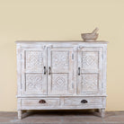Whitewashed hand carved wooden sideboard made from solid mango wood with floral patterns, 3 doors and 2 drawers; artisanal mango wood furniture, 120 × 100 × 40 cm.