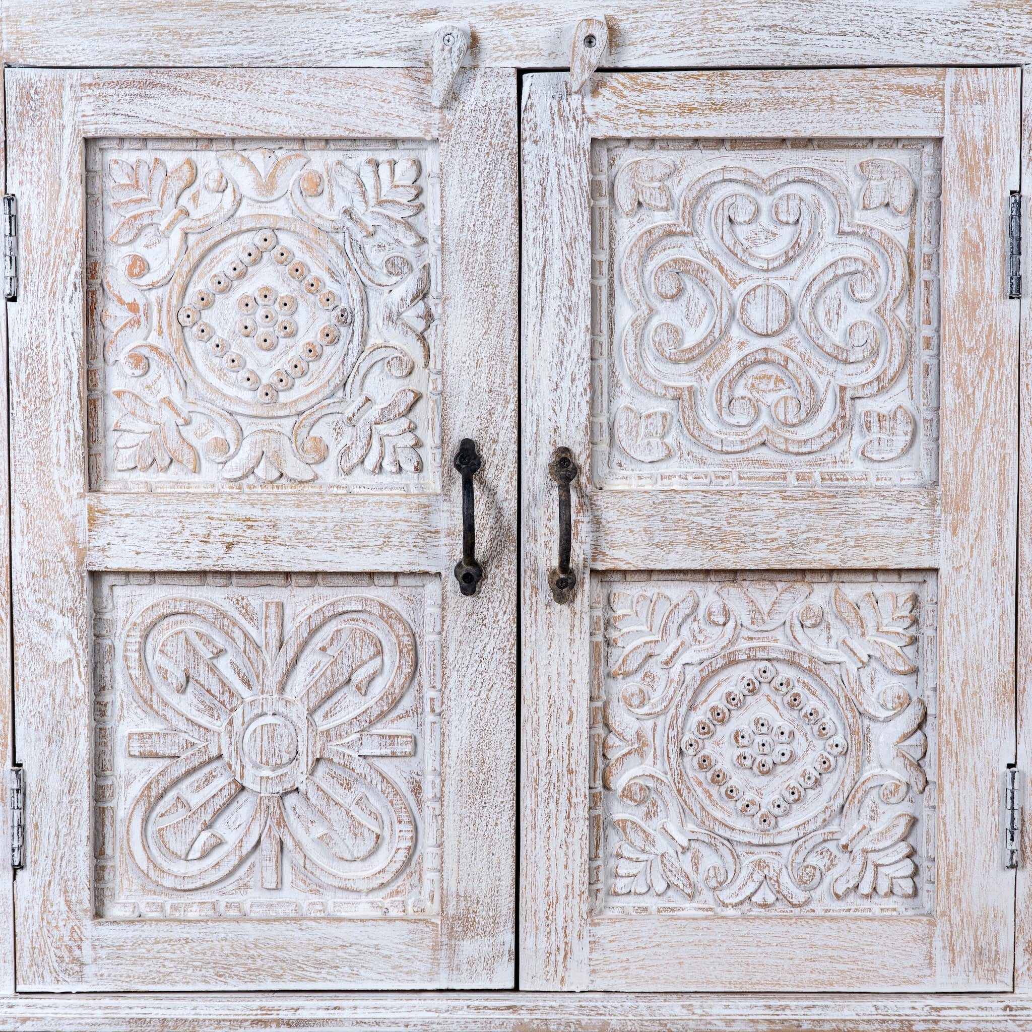 Close up image of a whitewashed hand carved wooden sideboard made from solid mango wood with floral patterns, 3 doors and 2 drawers; artisanal mango wood furniture, 120 × 100 × 40 cm.