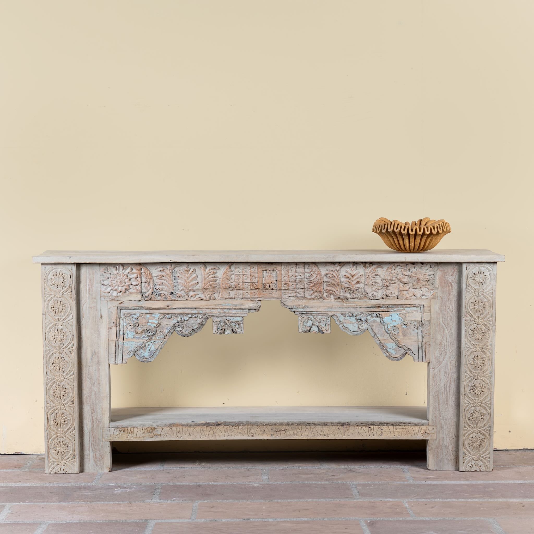 Karam reclaimed teak console table with hand-carved Indian details, lower shelf, and vintage whitewashed finish.