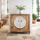 Lifestyle image of a carved wood furniture cabinet made from mango wood with floral detailing and whitewashed finish, 90 × 90 × 40 cm.