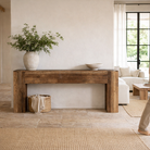 Lifestyle image of a rustic minimalistic console table made from reclaimed wood with preserved imperfections, block legs, 250 × 40 × 90 cm.