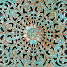 Close up image of a hand-carved mango wood wall panel with floral motifs in blue finish – Kataee Blue model by Om Home & Garden