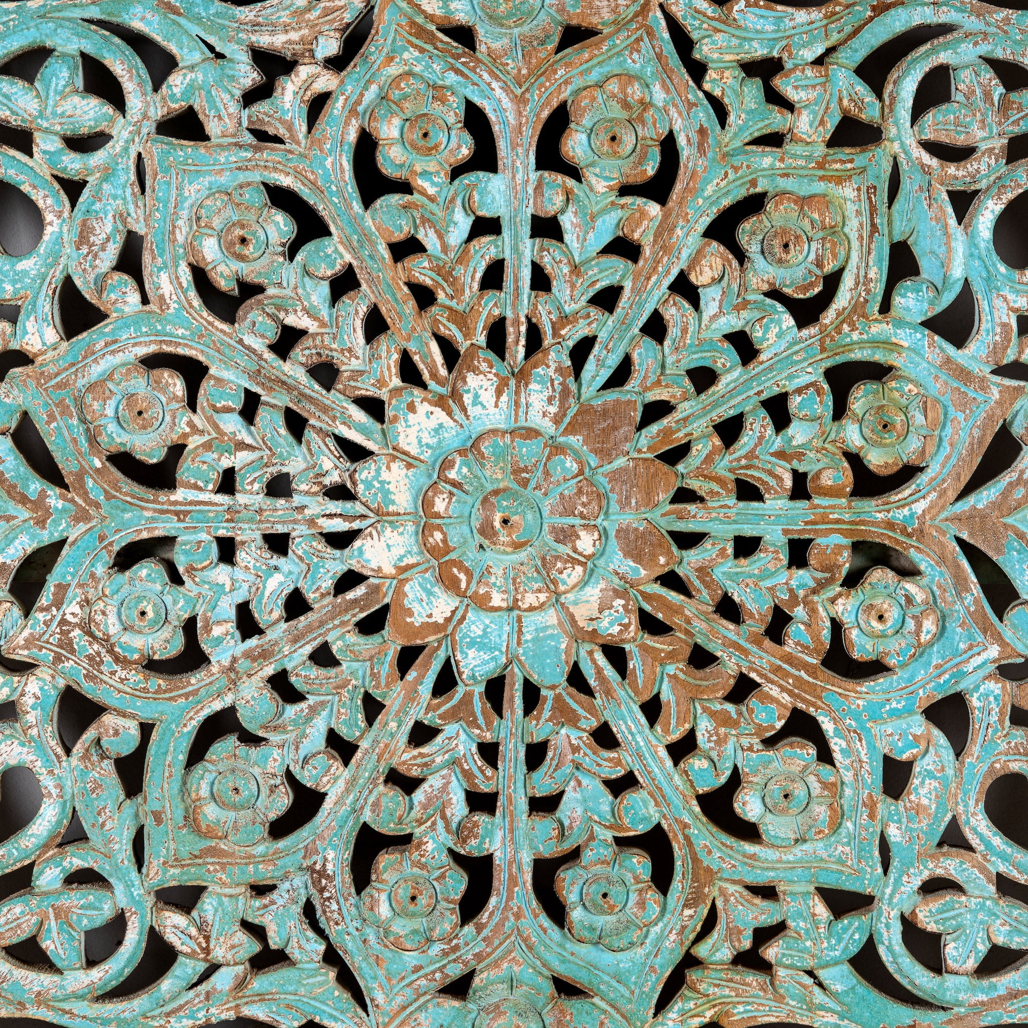 Close up image of a hand-carved mango wood wall panel with floral motifs in blue finish – Kataee Blue model by Om Home & Garden