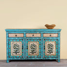 Kaveh hand painted reclaimed wood sideboard in boho style with three doors, three drawers, floral details, and distressed turquoise finish.