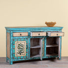 Side angle image with open door of a Kaveh hand painted reclaimed wood sideboard in boho style with three doors, three drawers, floral details, and distressed turquoise finish.