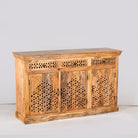 Side angle image of a hand-carved mango wood sideboard Kaveri with 6 compartments and 3 drawers, oriental-inspired mango wood furniture, 150 × 90 × 40 cm.