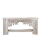 White background image of a Kayleb reclaimed teak console table with hand-carved Indian floral details, lower shelf, and whitewashed vintage finish.