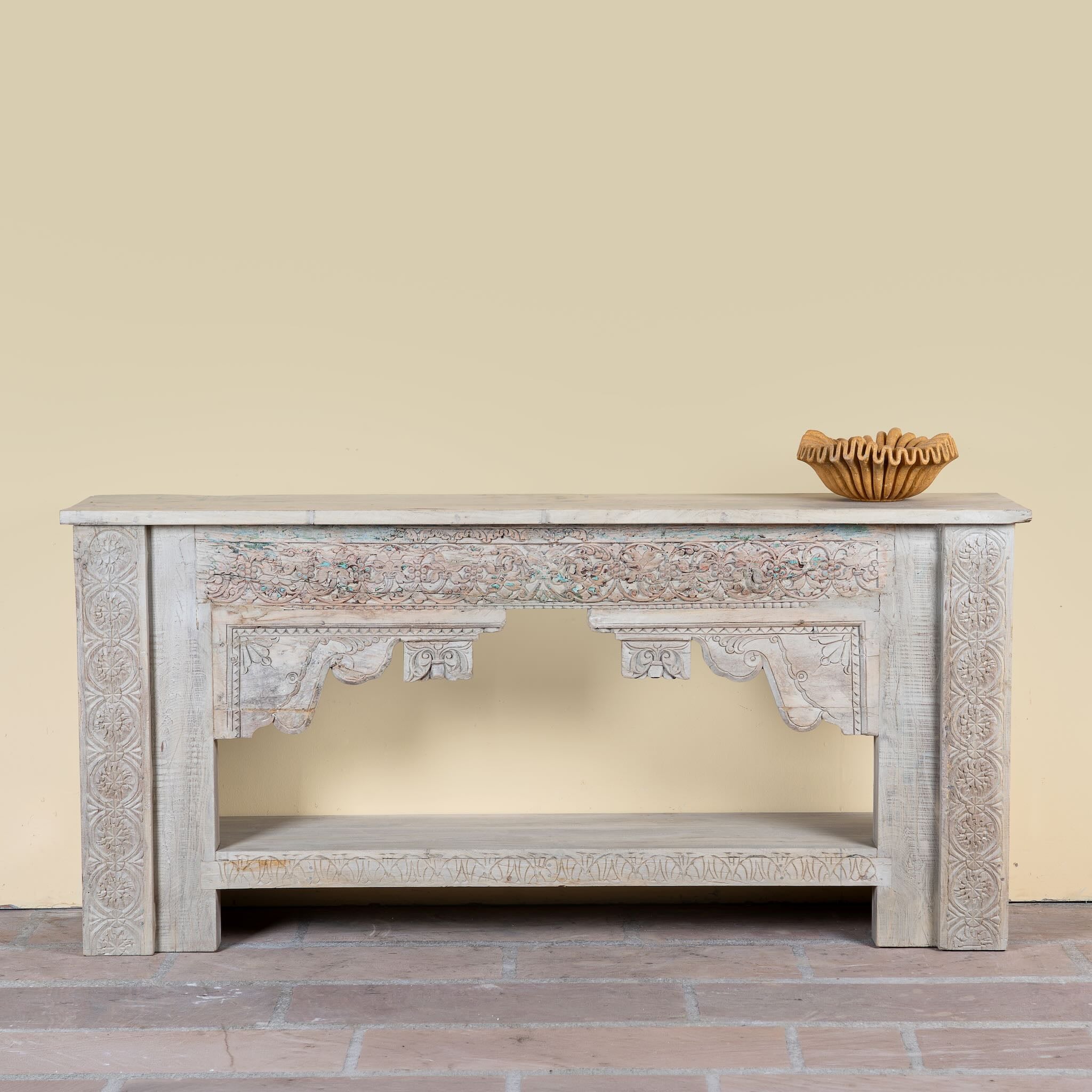 Kayleb reclaimed teak console table with hand-carved Indian floral details, lower shelf, and whitewashed vintage finish.