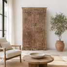 Lifestyle scene with a hand-carved reclaimed wood wardrobe with vintage finish – a sustainable furniture piece ideal for Indian home decor and rustic interiors.